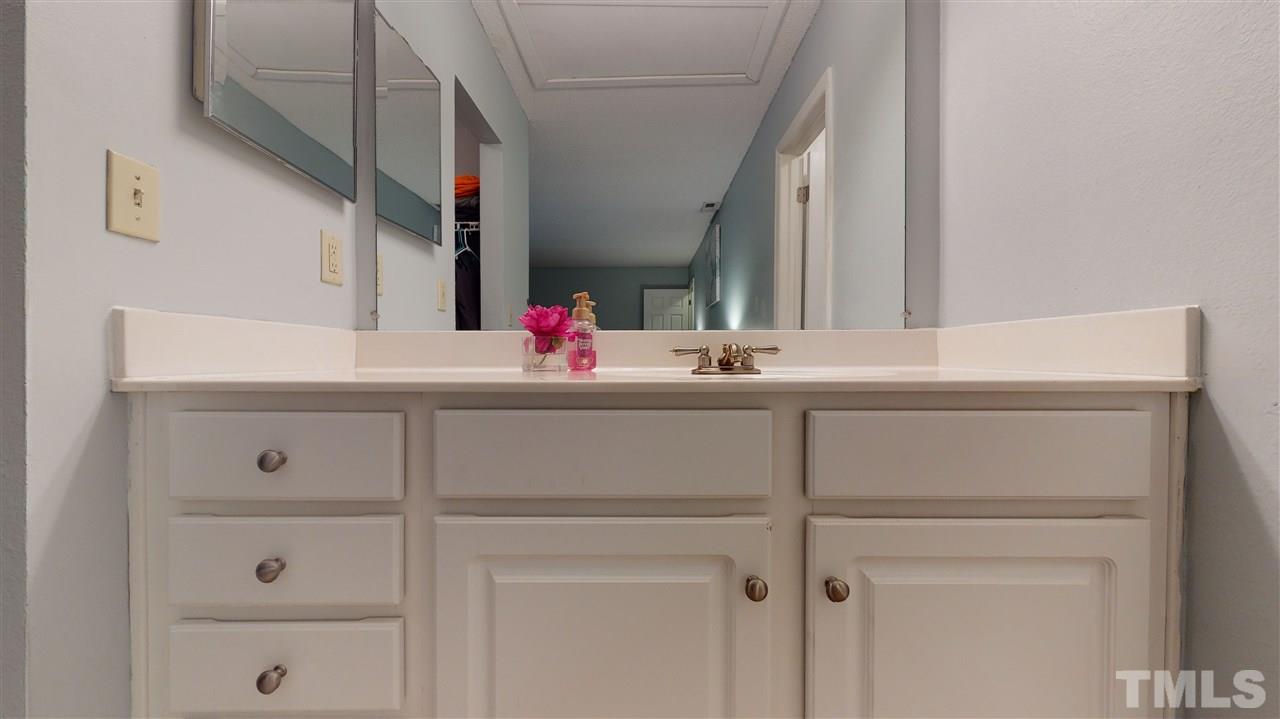 7744 Falcon Rest Circle Raleigh, NC 27615 - Photo 15 of 22 a bathroom with a sink and a mirror