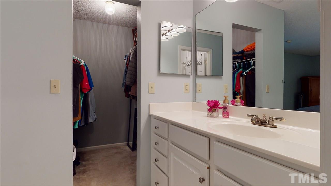 7744 Falcon Rest Circle Raleigh, NC 27615 - Photo 16 of 22 a bathroom with a sink vanity and a mirror