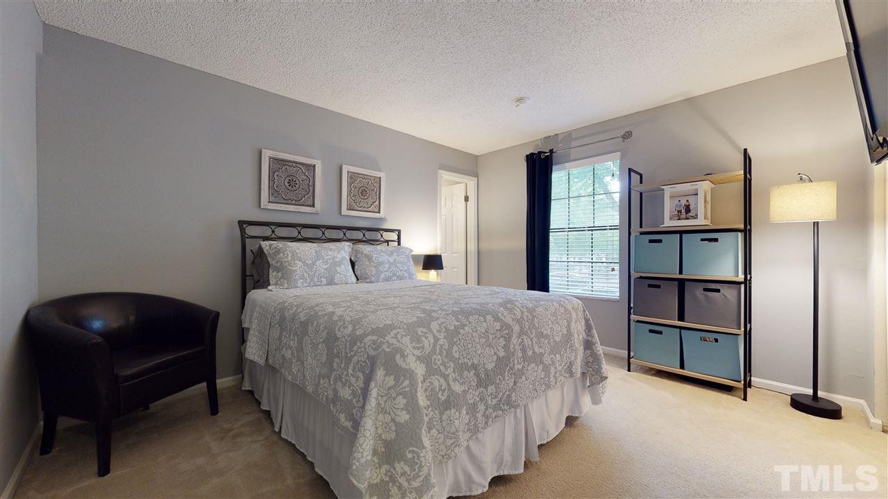 7744 Falcon Rest Circle Raleigh, NC 27615 - Photo 17 of 22 a bedroom with a bed and cabinets