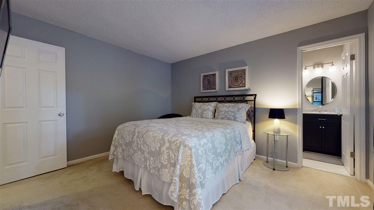 7744 Falcon Rest Circle Raleigh, NC 27615 - Photo 18 of 22 a bedroom with a bed and window