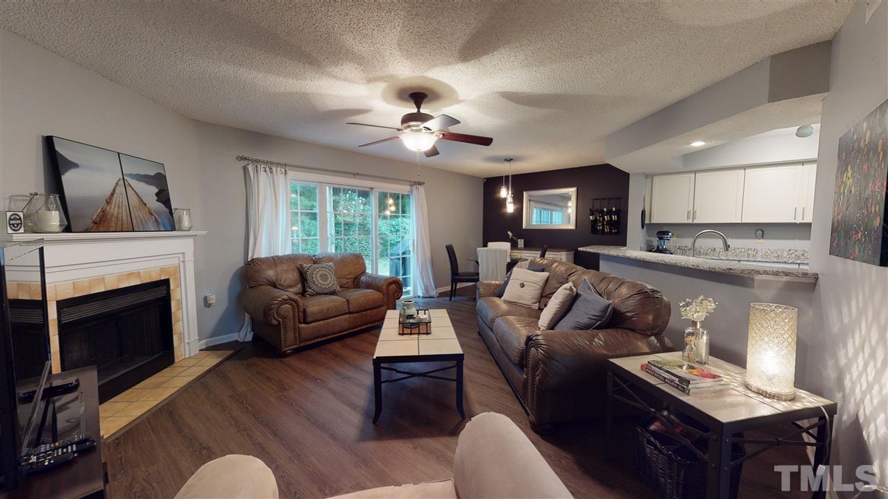 7744 Falcon Rest Circle Raleigh, NC 27615 - Photo 6 of 22 a living room with furniture and a fireplace