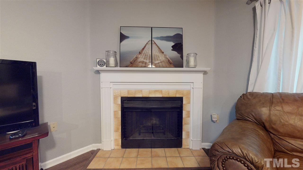 7744 Falcon Rest Circle Raleigh, NC 27615 - Photo 7 of 22 a living room with furniture and a fireplace