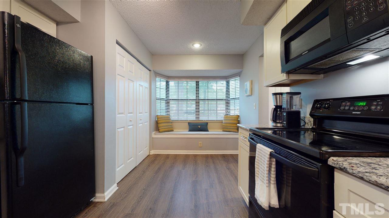 7744 Falcon Rest Circle Raleigh, NC 27615 - Photo 9 of 22 a kitchen with a refrigerator and a sink
