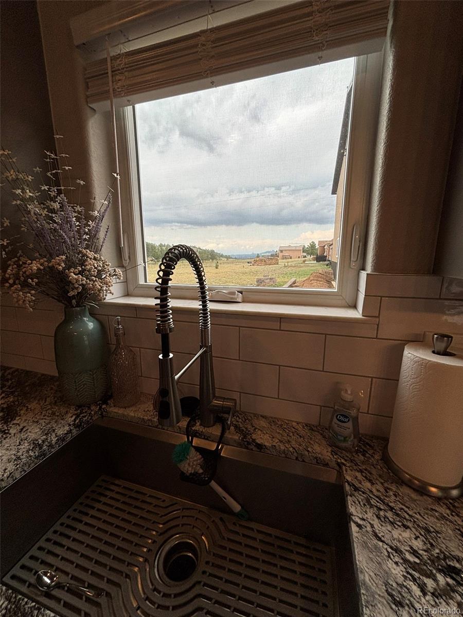 489 Duesouth Road Florissant, CO 80816 - Photo 30 of 40 a bathroom with a granite countertop sink and a mirror