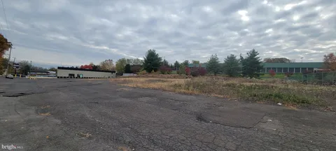 a view of dirt field with trees
