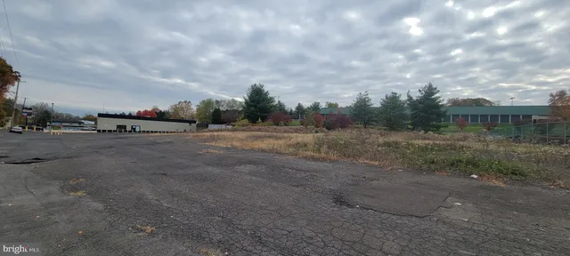 a view of dirt field with trees