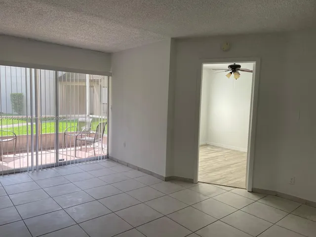 an empty room with sliding door and mountain view