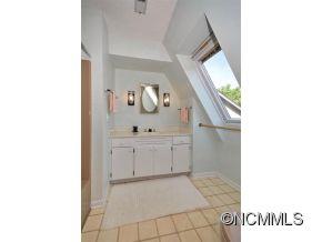 1400 South Wilson Hill Road Mill Spring, NC 28756 - Photo 13 of 24 a bathroom with a sink and mirror