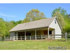 1400 South Wilson Hill Road Mill Spring, NC 28756 - Photo 19 of 24 a view of a house with a garden