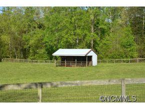 1400 South Wilson Hill Road Mill Spring, NC 28756 - Photo 22 of 24 a front view of a house with a yard