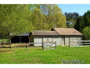 1400 South Wilson Hill Road Mill Spring, NC 28756 - Photo 23 of 24 a front view of a house with a yard