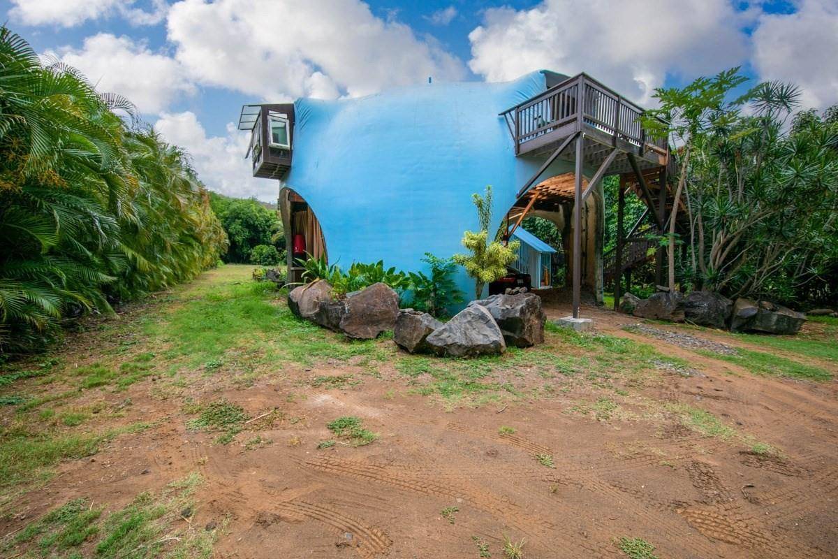 a backyard of a house with table and chairs