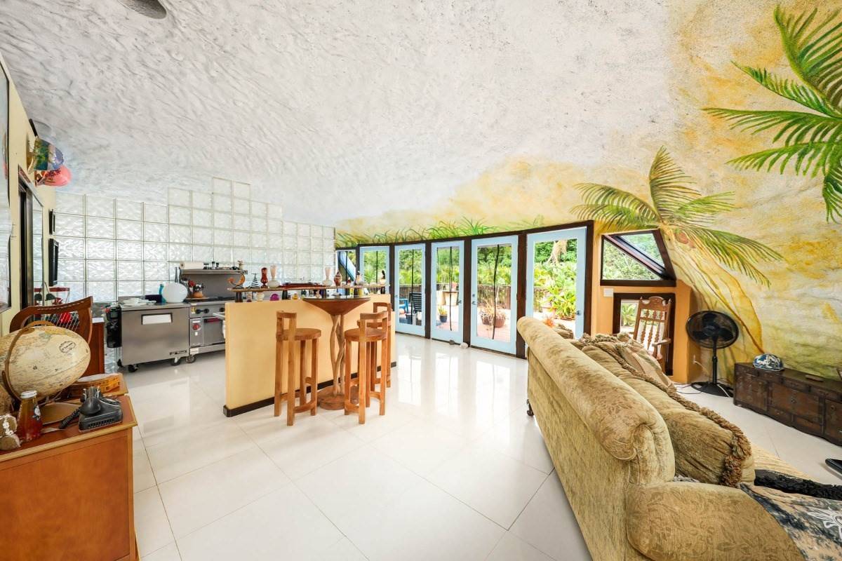 5390 Menehune Road Waimea, HI 96796 - Photo 2 of 22 a living room with furniture floor to ceiling window and a flat screen tv