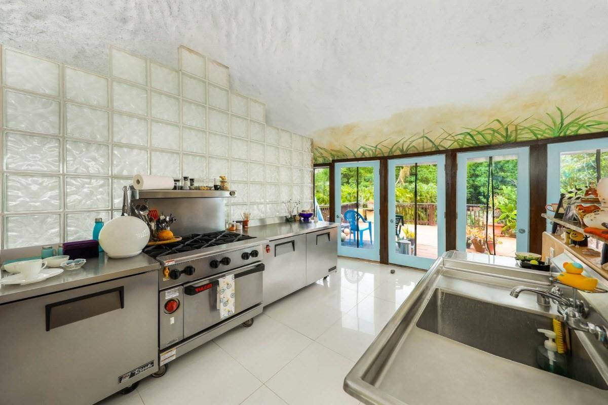 5390 Menehune Road Waimea, HI 96796 - Photo 5 of 22 a kitchen with a stove and a large window