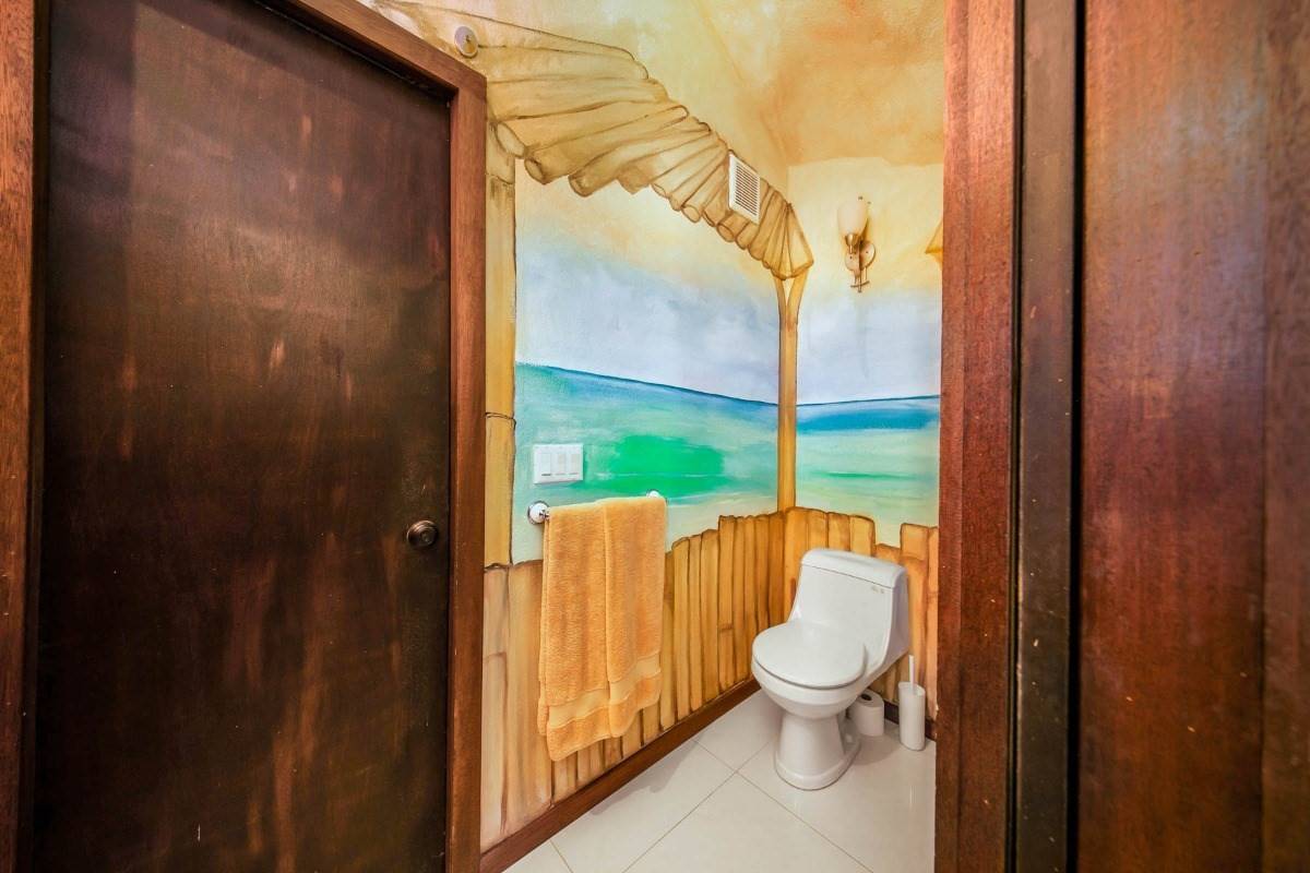 5390 Menehune Road Waimea, HI 96796 - Photo 9 of 22 a bathroom with a granite countertop toilet and a shower