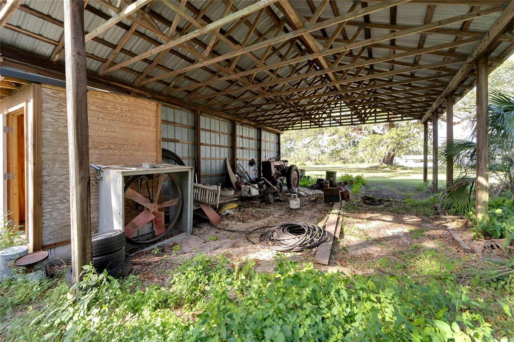 5020 Sydney Road Plant City, FL 33566 - Photo 12 of 33 a view of a backyard with plants and a patio