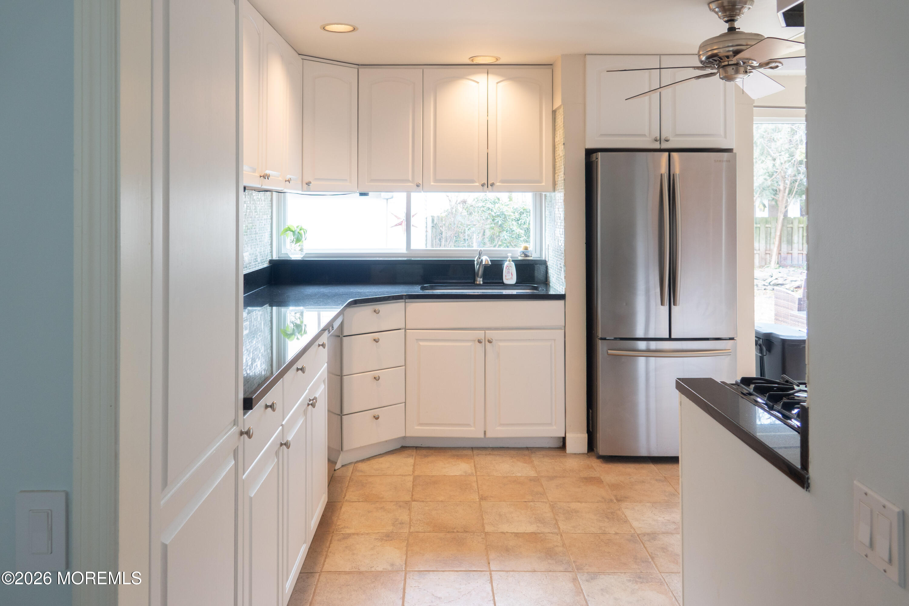 480 Staffa Street Allenhurst, NJ 07711 - Photo 18 of 30 a kitchen with granite countertop a refrigerator and a sink