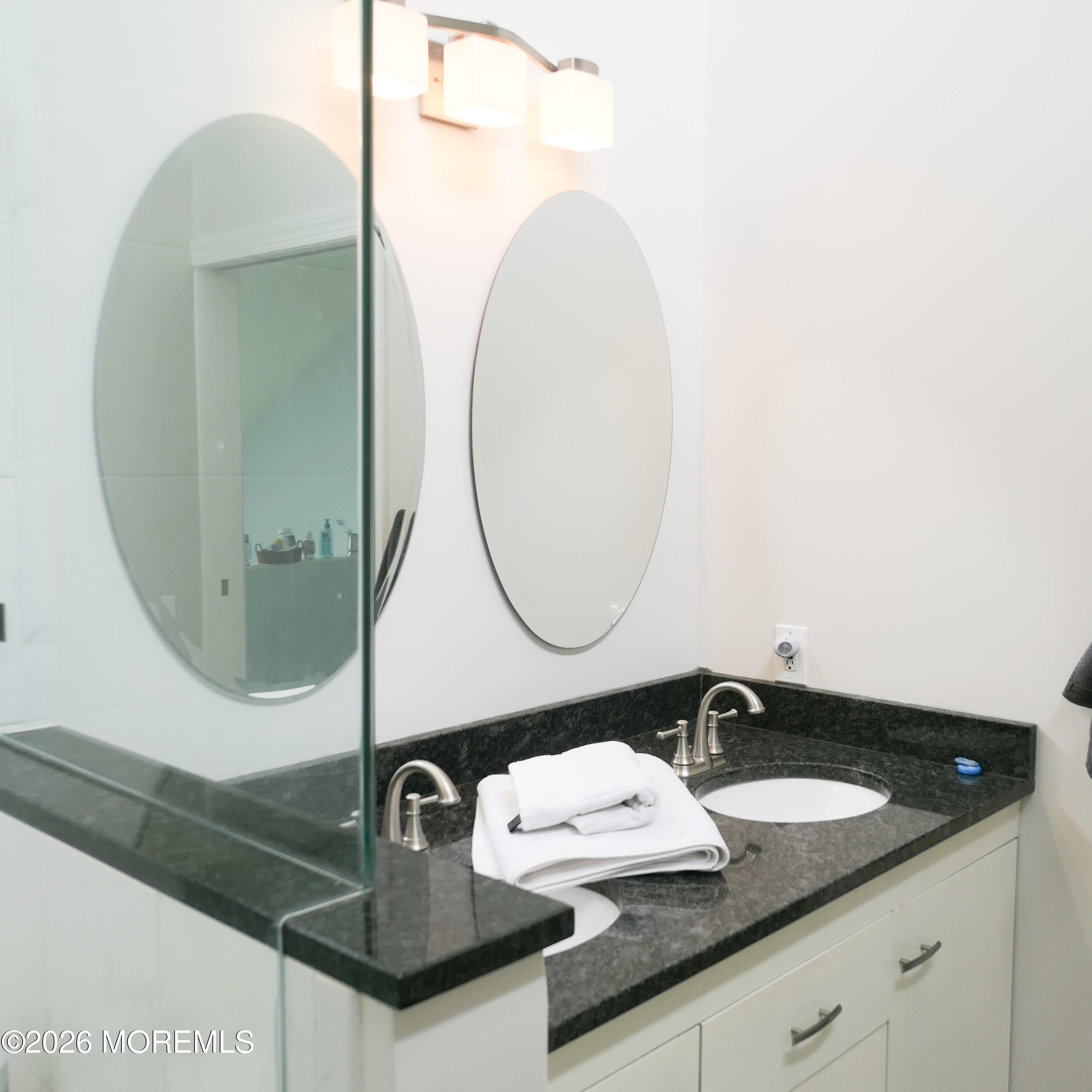 480 Staffa Street Allenhurst, NJ 07711 - Photo 25 of 30 a bathroom with a sink and a mirror