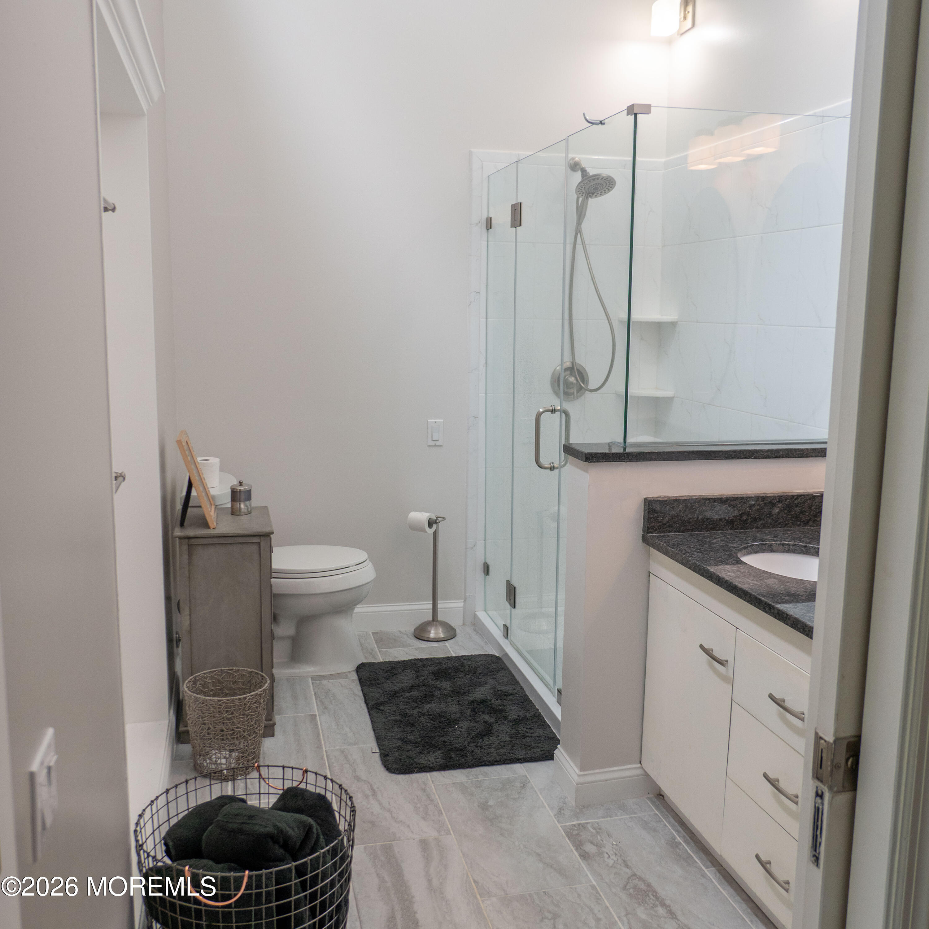 480 Staffa Street Allenhurst, NJ 07711 - Photo 26 of 30 a bathroom with a granite countertop toilet and a shower