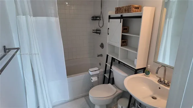 a white toilet sitting next to a bathroom sink
