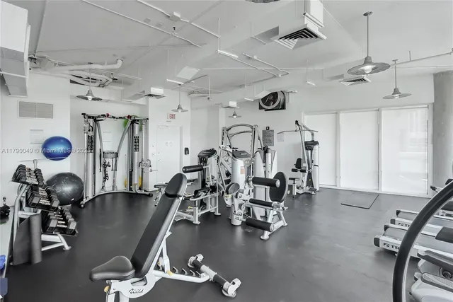 a gym room with lots of gym equipment