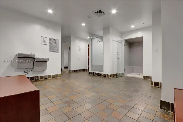 an empty room with fireplace and cabinet