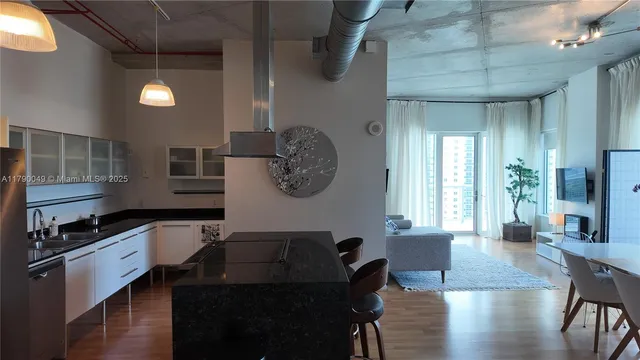 a kitchen with a table chairs and cabinets