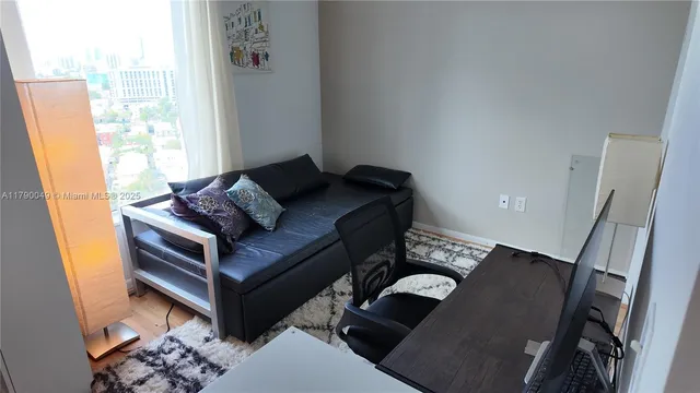 a living room with furniture and a window