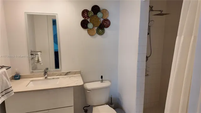 a bathroom with a sink a toilet and mirror