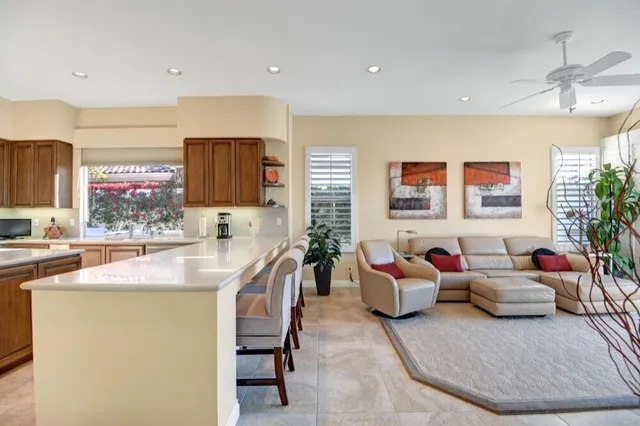 a living room with furniture and a kitchen