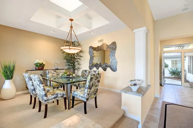 a dining room with furniture potted plants
