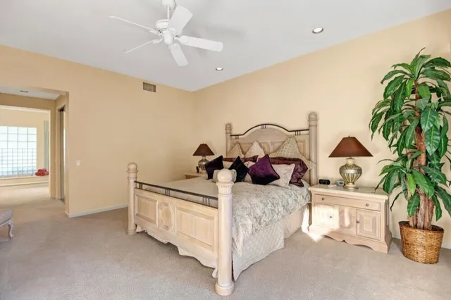 a bedroom with bed and a potted plant