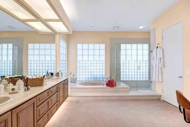 a spacious bathroom with sinks mirror and a bathtub