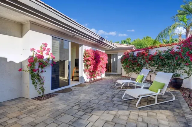a patio with table and chairs