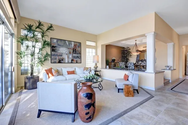a living room with furniture and a large window