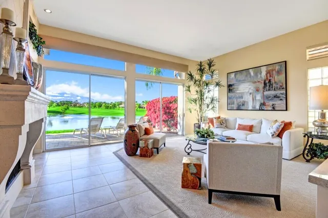 a living room with furniture and a potted plant