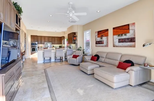 a living room with furniture and a kitchen