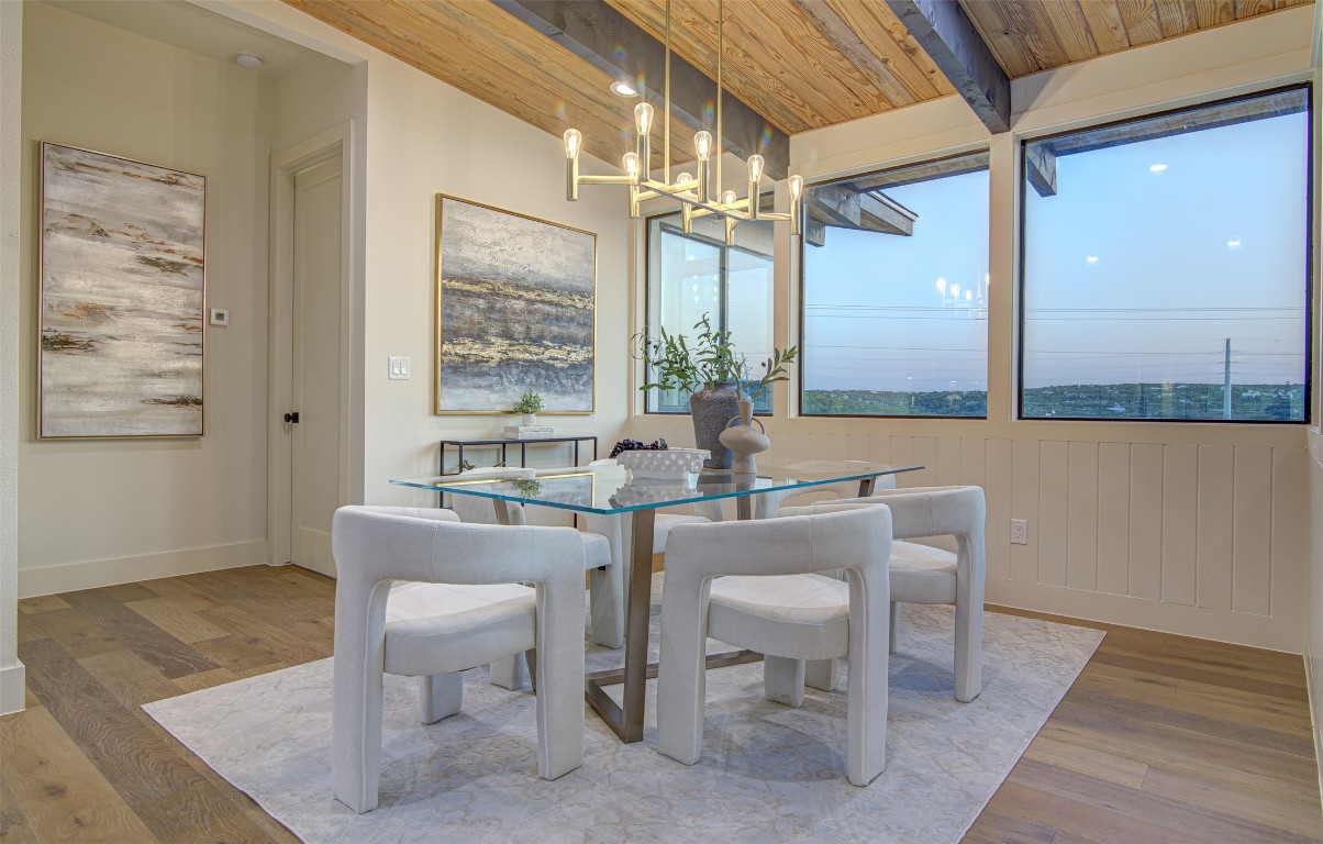 19543 Lakehurst Loop Spicewood, TX 78669 - Photo 8 of 23 a view of a dining room with furniture window and wooden floor