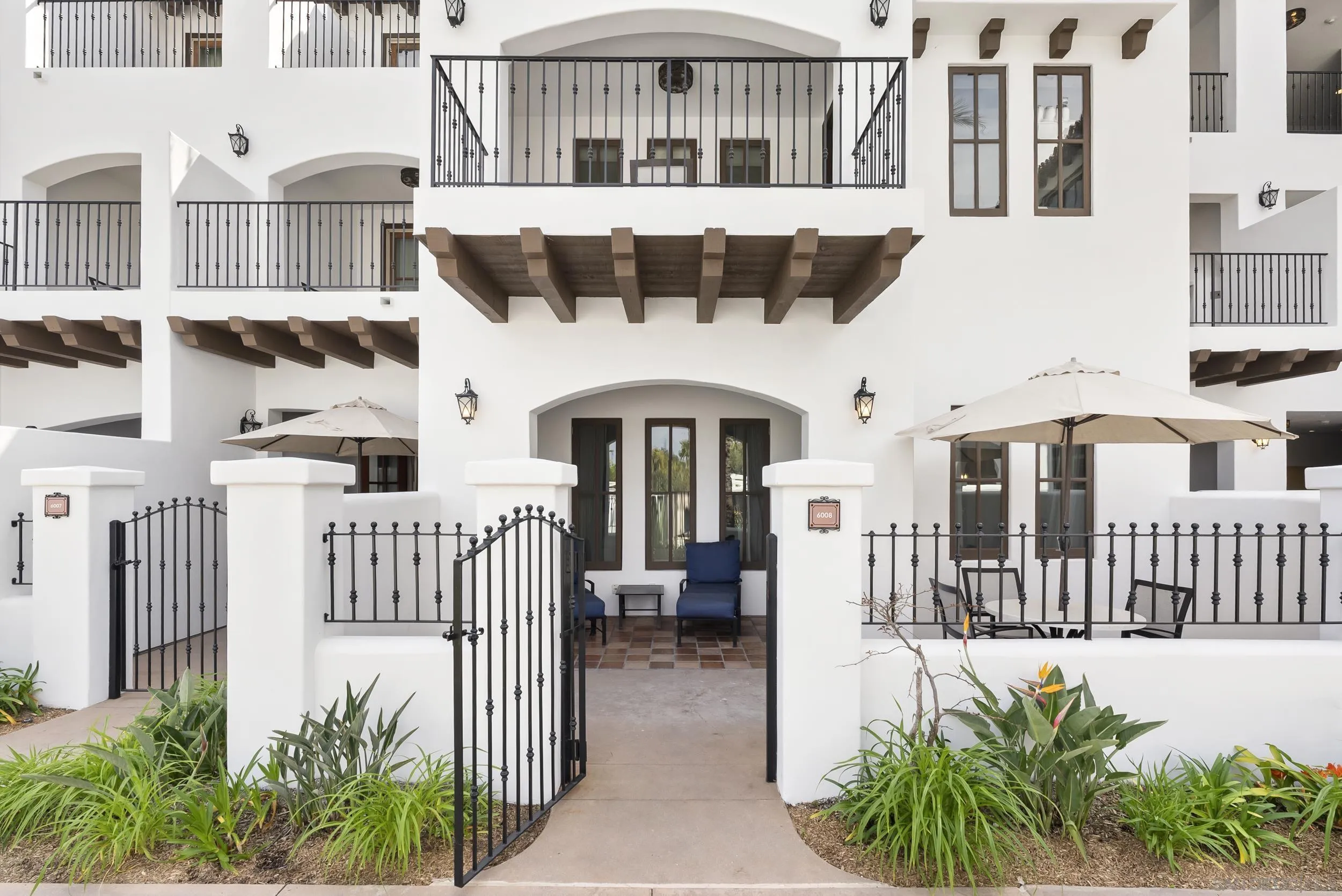 a front view of a building with a garden