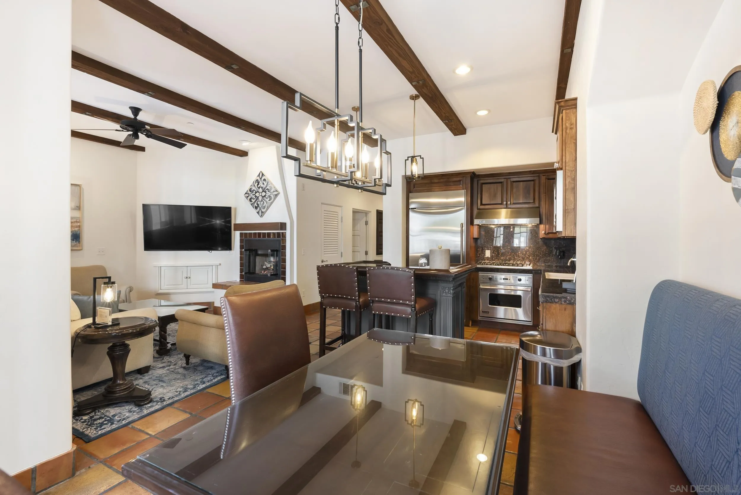 7310 Estrella De Mar Road, Unit 3 Carlsbad, CA 92009 - Photo 12 of 32 a living room with furniture a flat screen tv and kitchen view