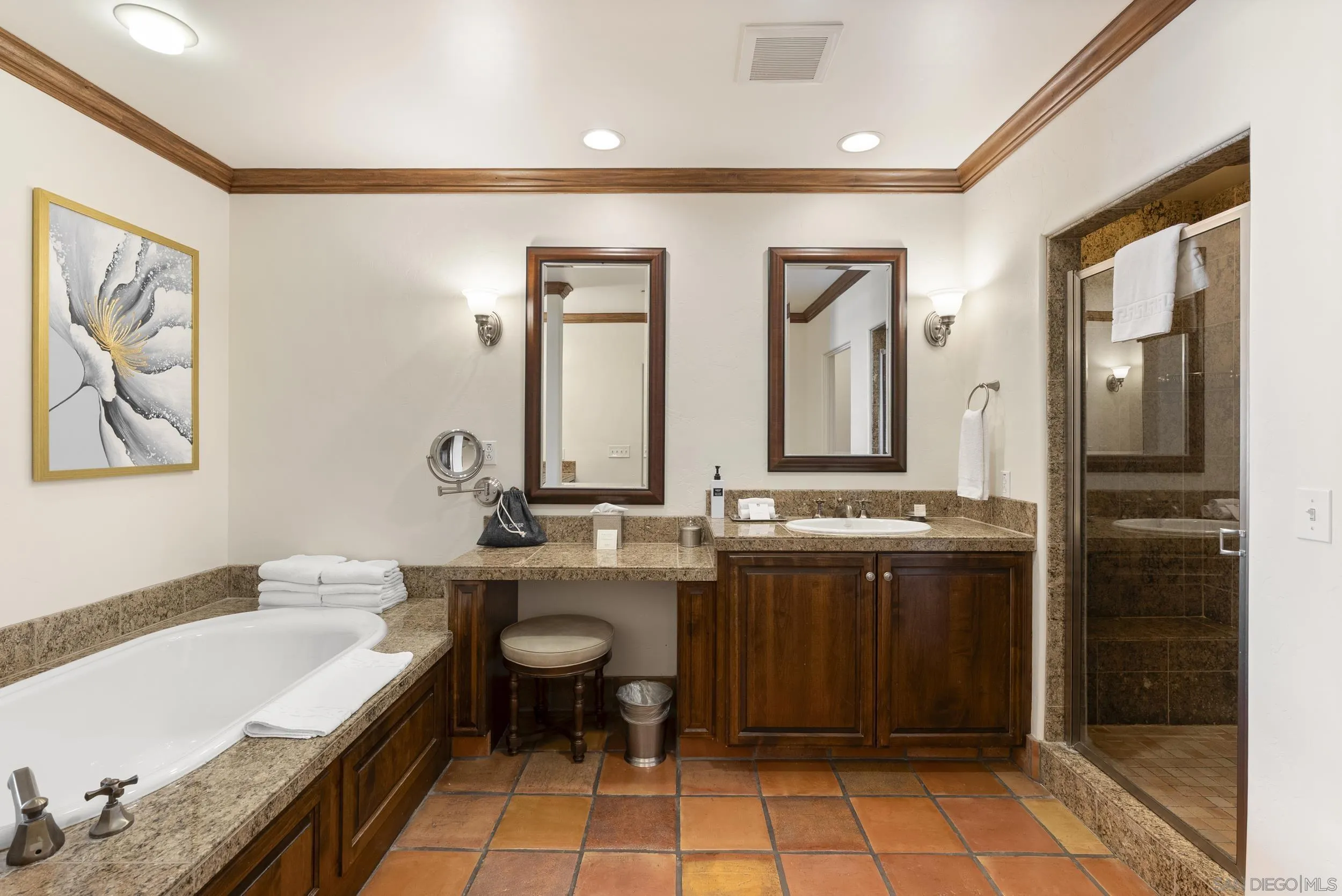 7310 Estrella De Mar Road, Unit 3 Carlsbad, CA 92009 - Photo 19 of 32 a bathroom with a double vanity sink a mirror and a bathtub