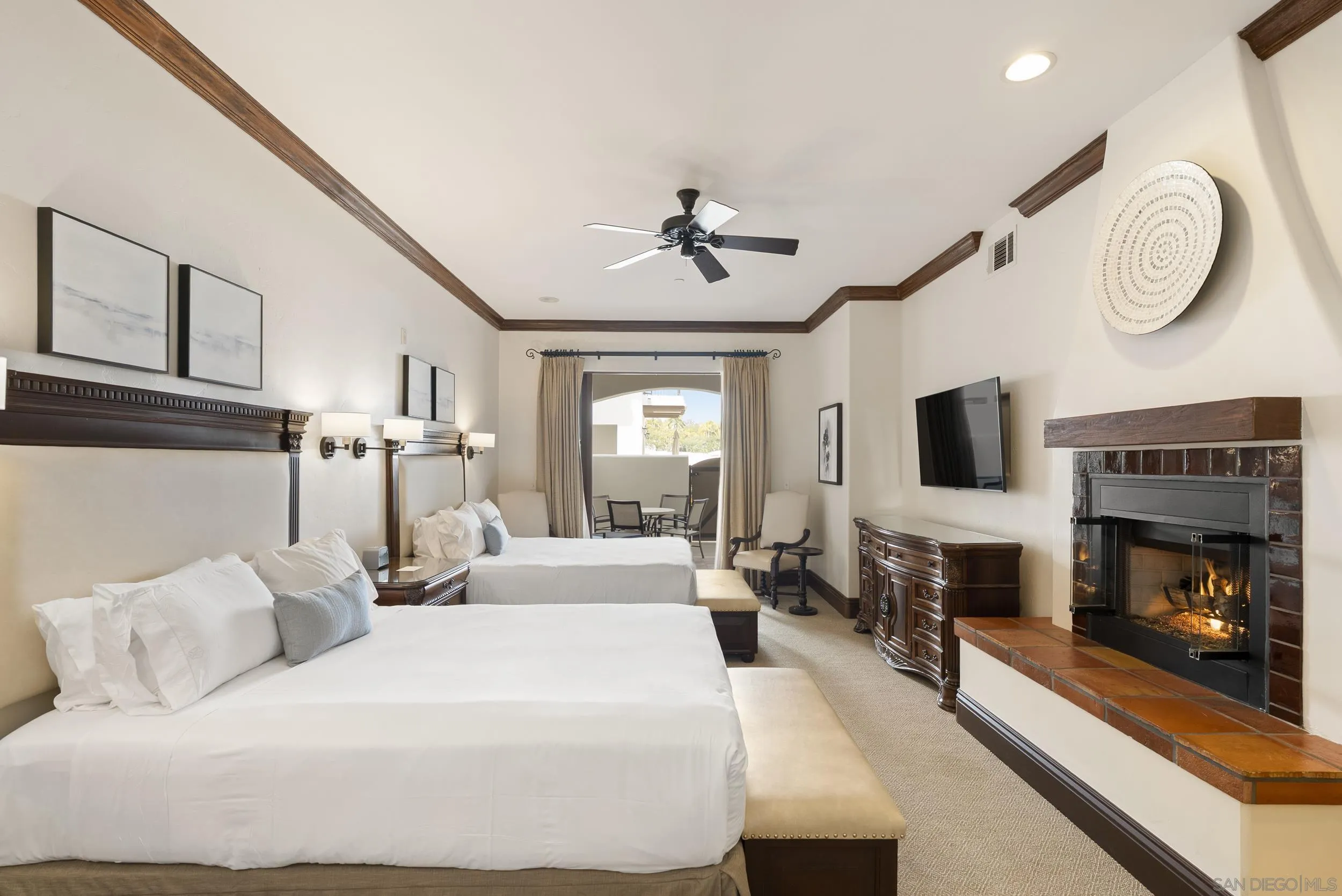 7310 Estrella De Mar Road, Unit 3 Carlsbad, CA 92009 - Photo 21 of 32 a bedroom with a large bed and a fireplace