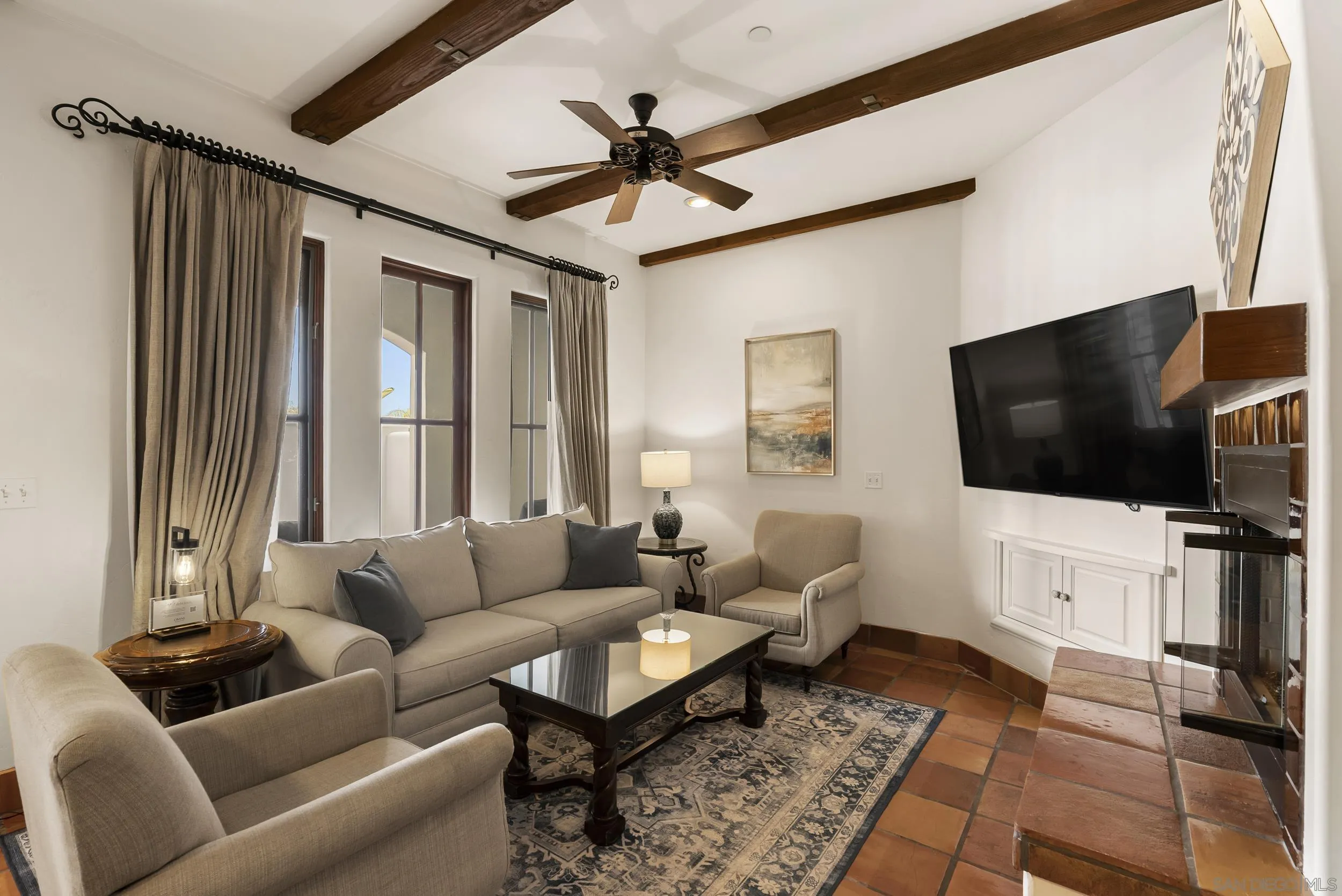 7310 Estrella De Mar Road, Unit 3 Carlsbad, CA 92009 - Photo 6 of 32 a living room with furniture and a flat screen tv