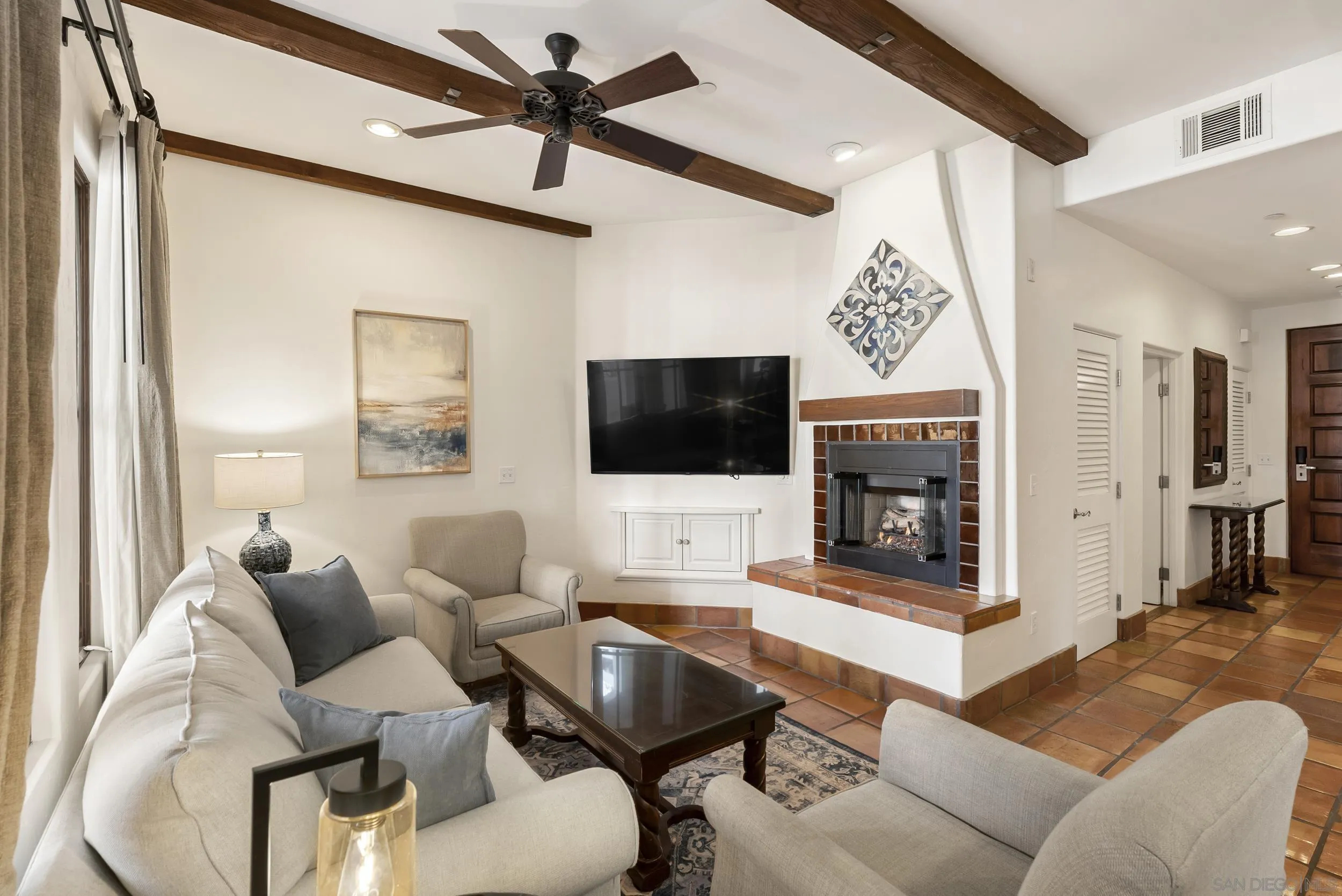 7310 Estrella De Mar Road, Unit 3 Carlsbad, CA 92009 - Photo 7 of 32 a living room with furniture a flat screen tv and a fireplace