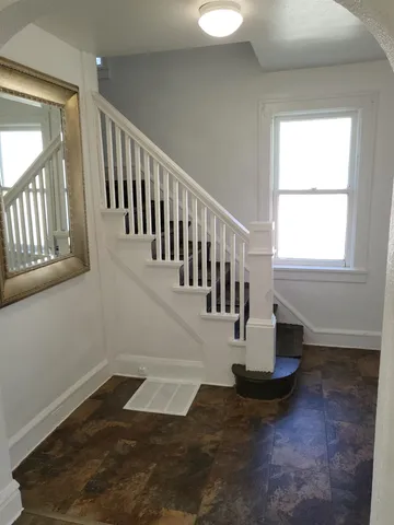 a view of entryway and hall with wooden floor