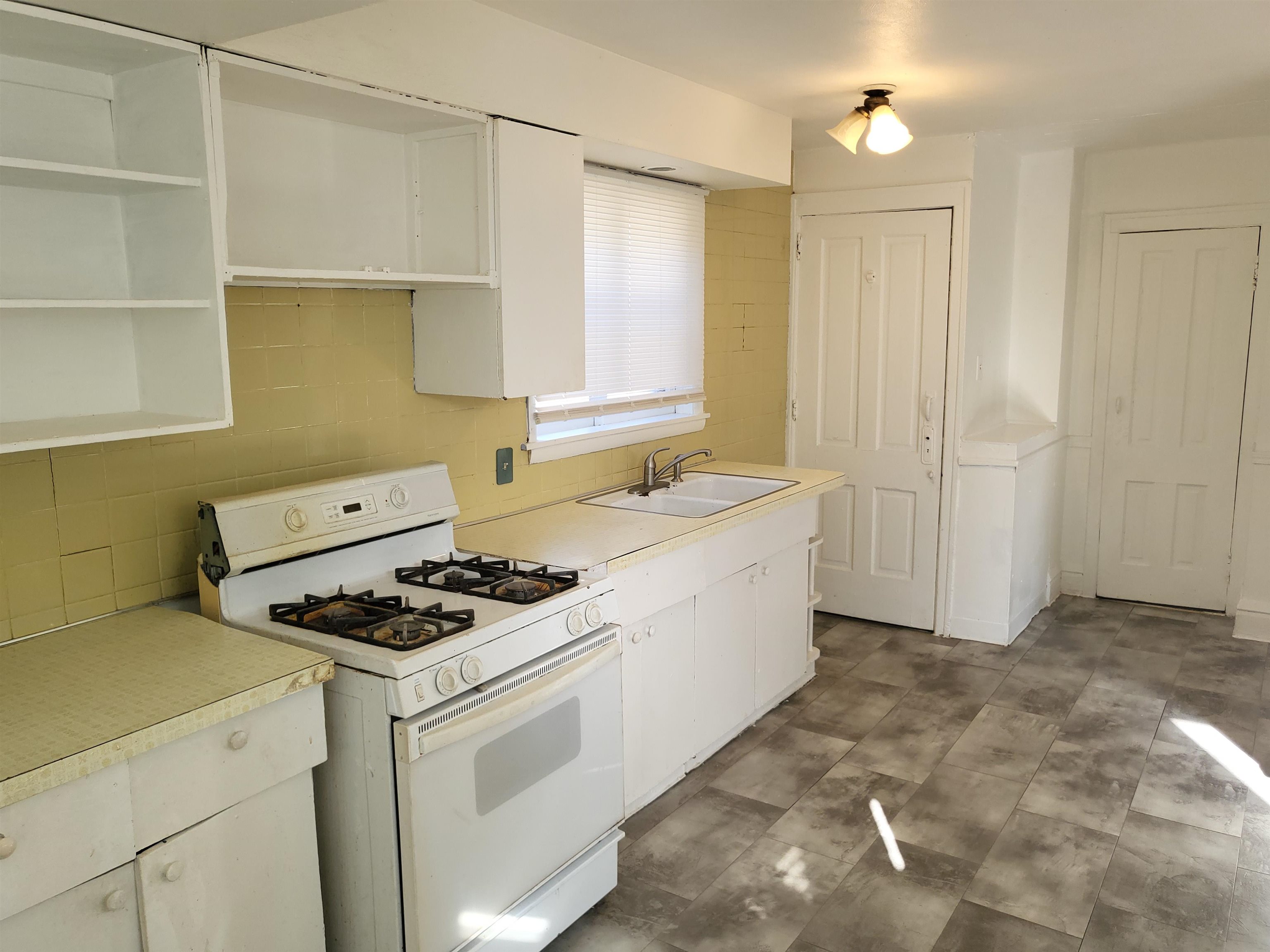 1433 5th Avenue Rockford, IL 61104 - Photo 7 of 19 a kitchen that has a sink and a stove