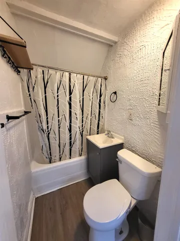 a white toilet sitting next to a bathroom sink