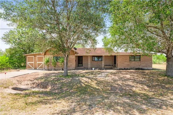 a house that has a tree in front of it
