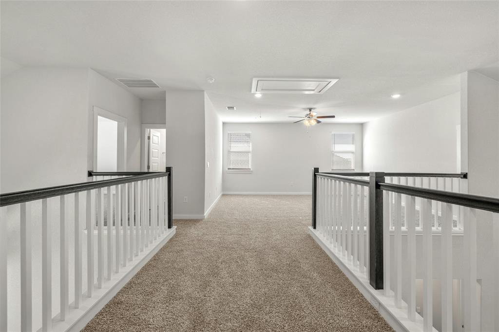 113 Shadow Oak Cove Georgetown, TX 78628 - Photo 25 of 40 A spacious carpeted loft area offers ample room for relaxation and various activities.