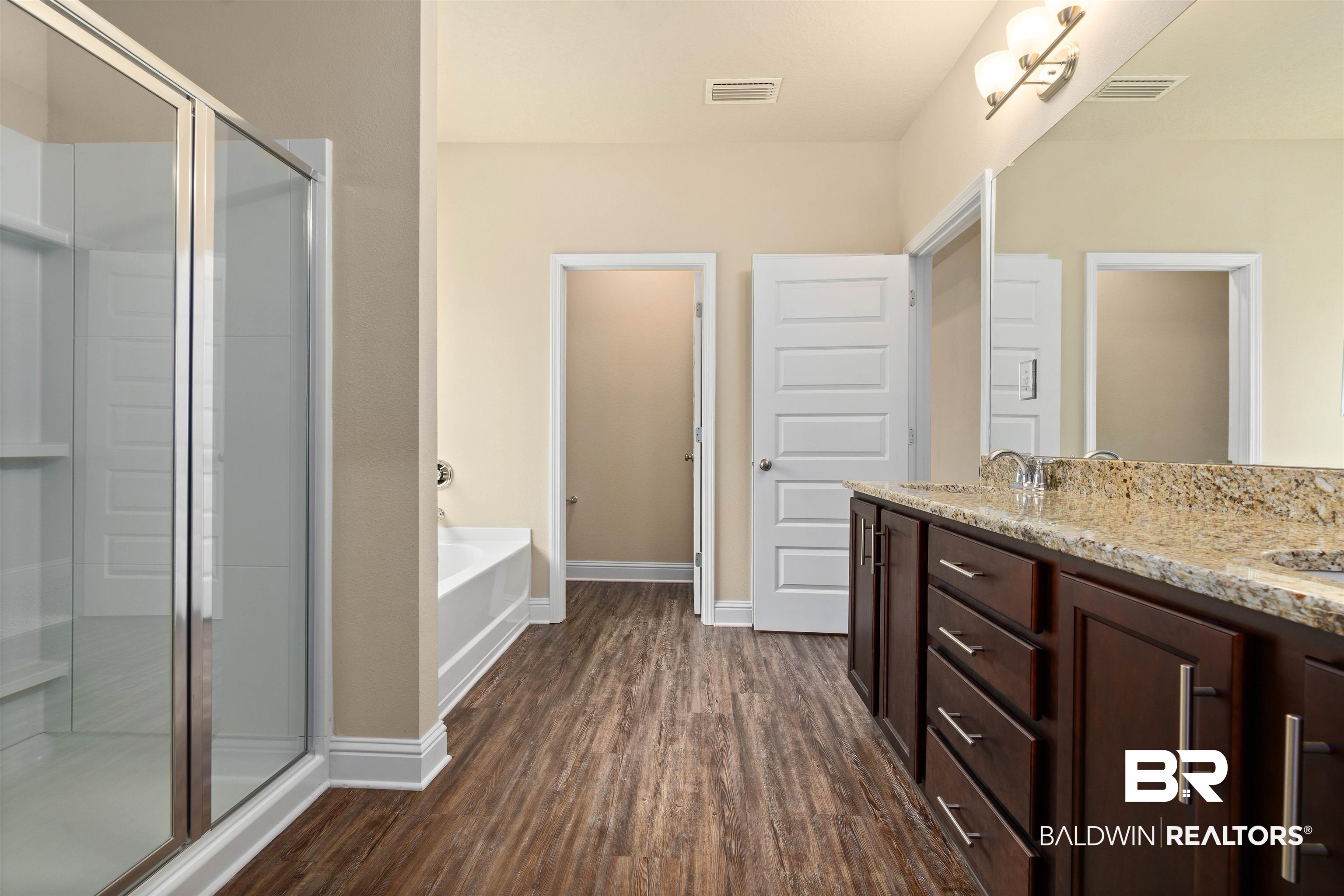 1864 Gwin Court Mobile, AL 36695 - Photo 22 of 37 Bathroom featuring wood-type flooring, shower with separate bathtub, and dual bowl vanity